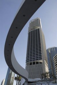 Tall modern building with curved frontage and deep blue sky