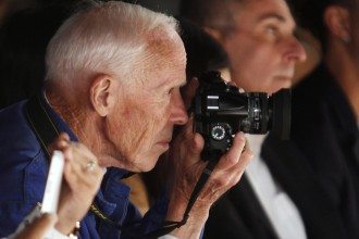 New York Times photographer Bill Cunningham takes photos during the Naeem Khan Spring/Summer 2013 collection show at New York Fashion Week