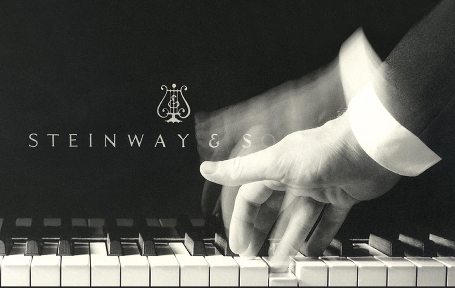 steinway hand playing on keyboard