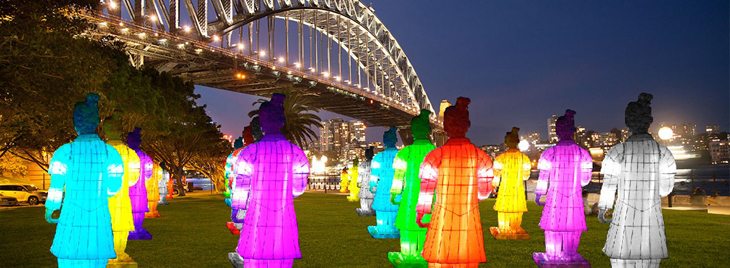 Lantern Warriors stand silently against the spectacular backdrop of Sydney Harbour